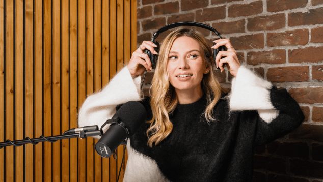 White woman with blond hair in a radio studio, putting headphones on. Photo by Edward Moore (c) British Council