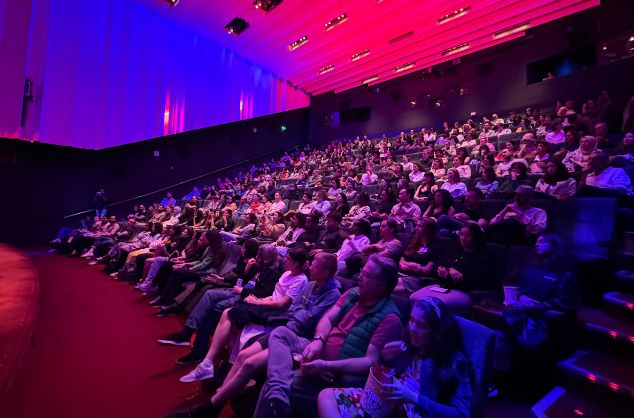 A cinema audience watches the screen