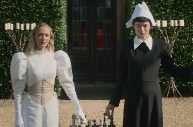 Still from 100 Nights of Hero showing two characters in unusual costumes looking at the camera while playing chess