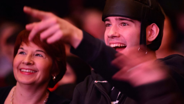 White learning disabled man pointing from a theatre crowd © Birmingham Hippodrome