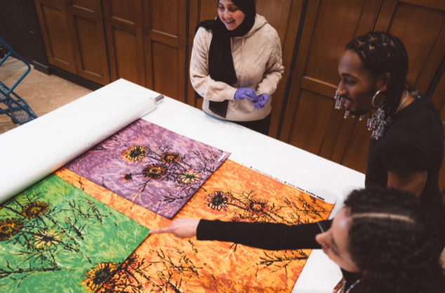 Creatives look at art works in V&A East's Study Centre. Photo by Bet Bettencourt, courtesy V&A East