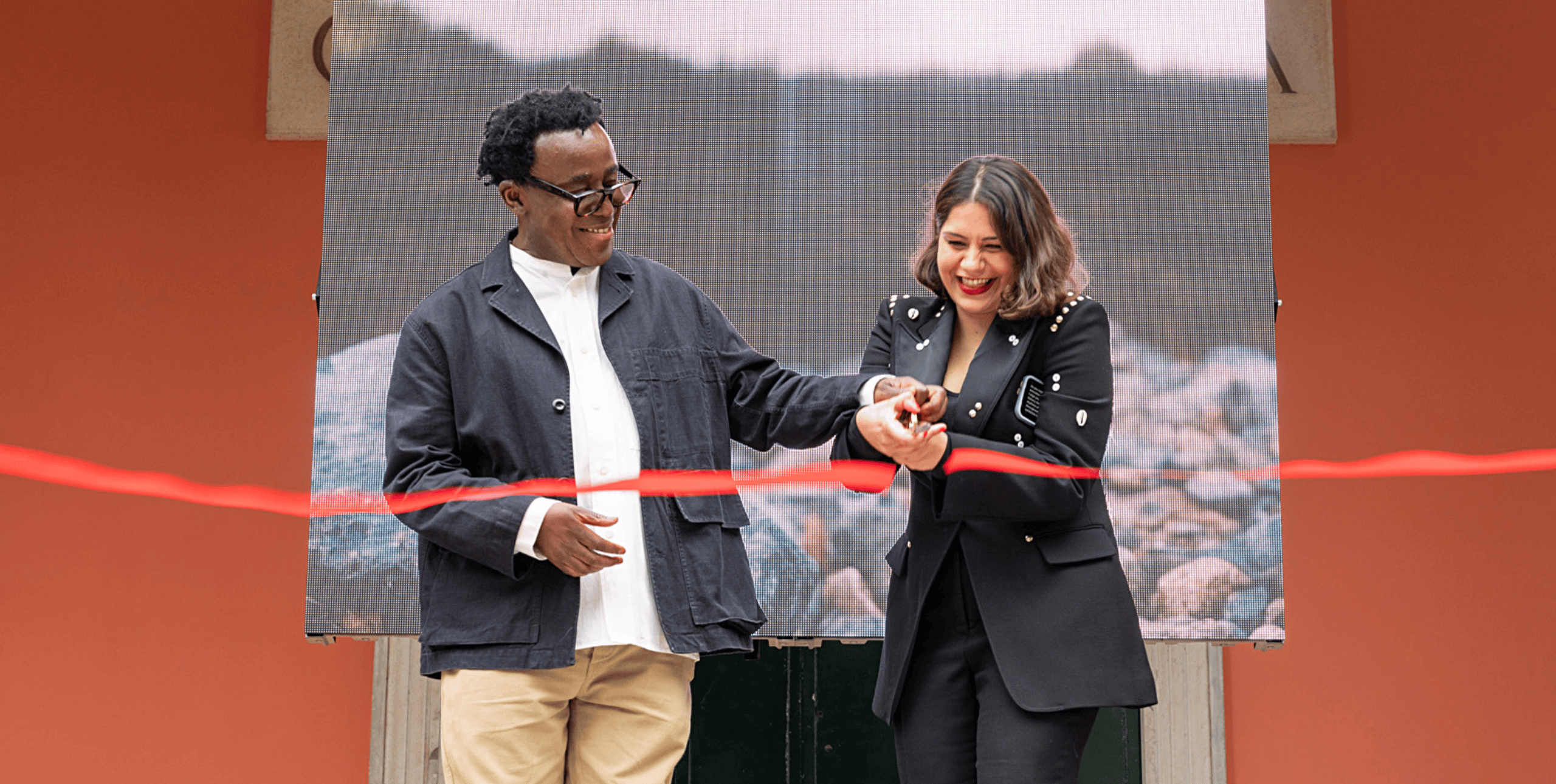 Artist John Akomfrah and curator Tarini Malik cut the ribbon at the British Pavilion opening ceremony at the Venice Biennale 2024. Photo by Cristiano Corte © British Council