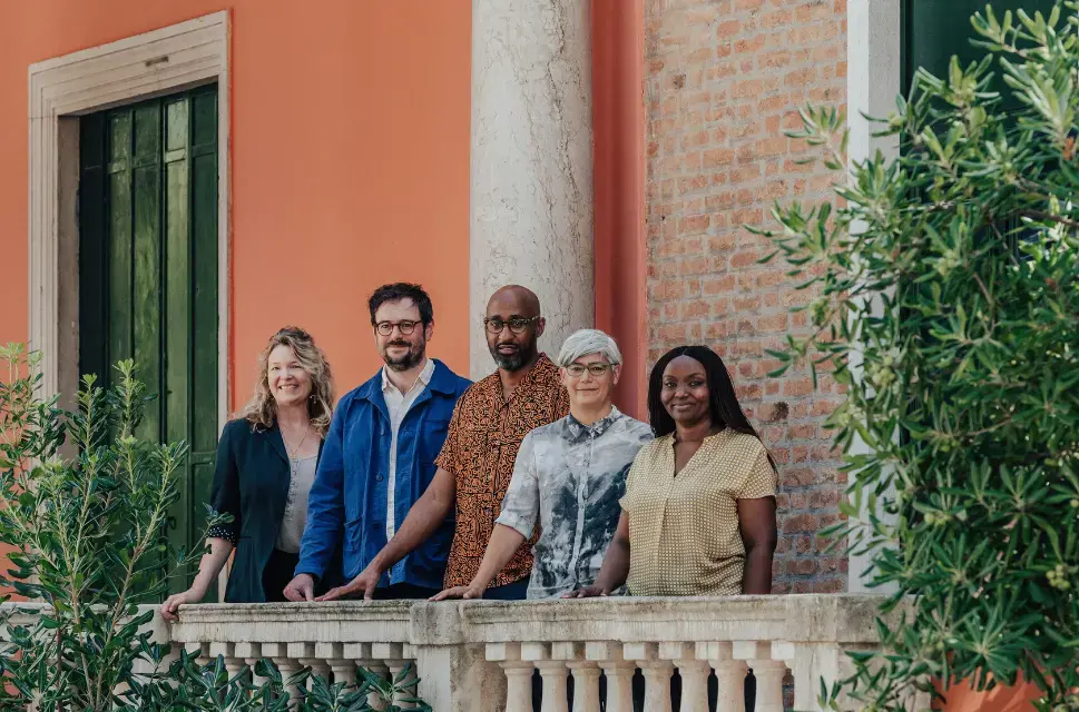 The curatorial team for the British Pavilion at the Venice Biennale 2025 stand in a row in front of the British Pavilion building. Left to right: Sevra Davis, Owen Hopkins, Kabage Karanja, Dr Kathryn Yusoff and Stella Mutegi