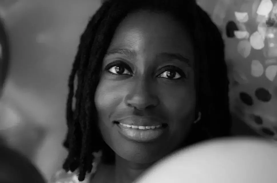 A portrait of the writer Helen Oyeyemi by Kateřina Janišová. Helen's face is tightly framed, with what appears to be balloons around her. The image is in black and white.