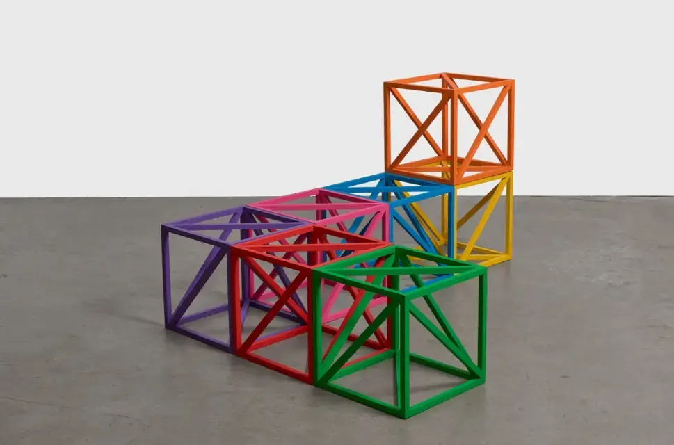 Square, see-through blocks in different colours on plain floor.