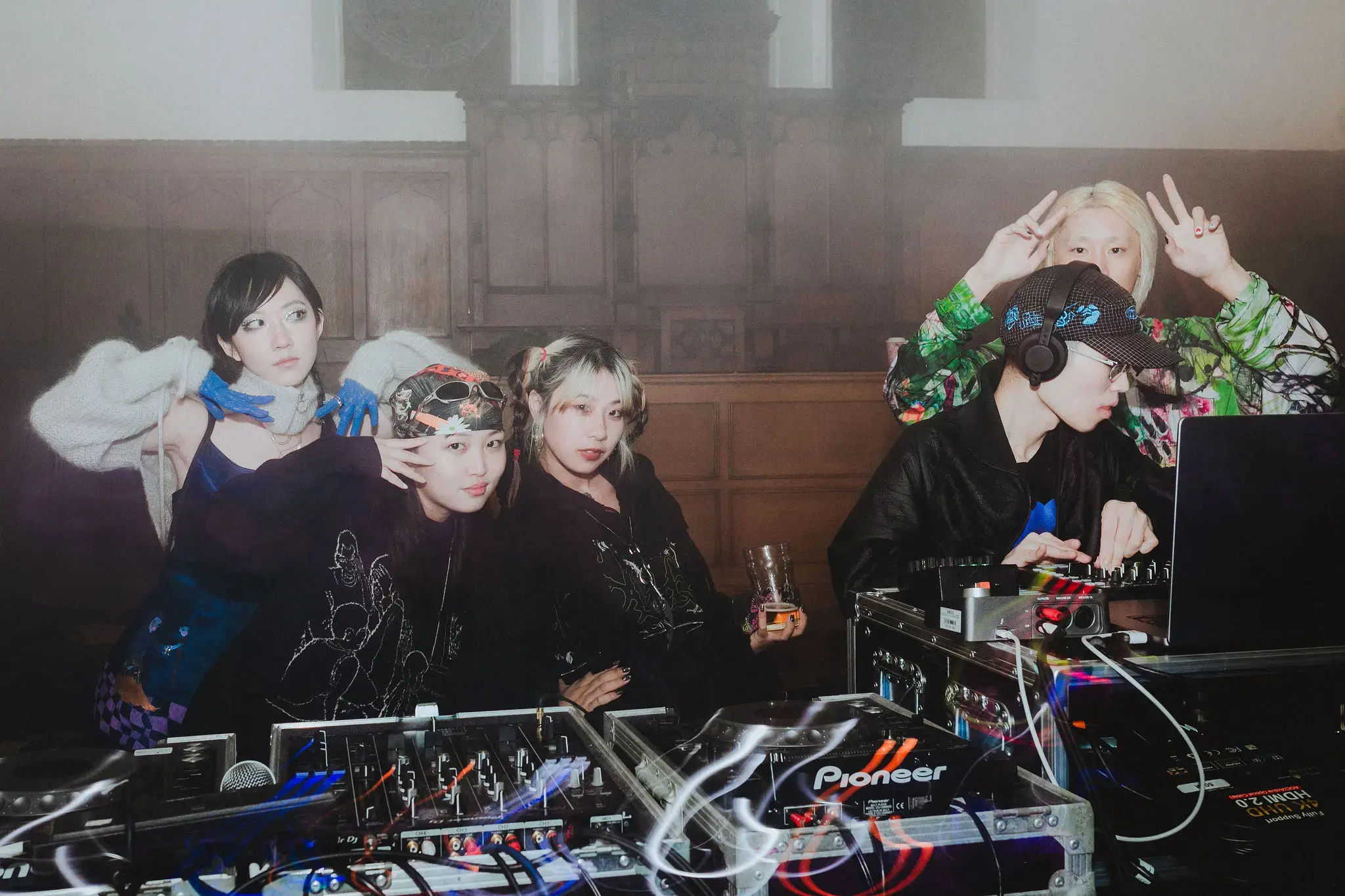 Young girls pose around the DJ at Fabrica, a collaboration between video club and martin goya business