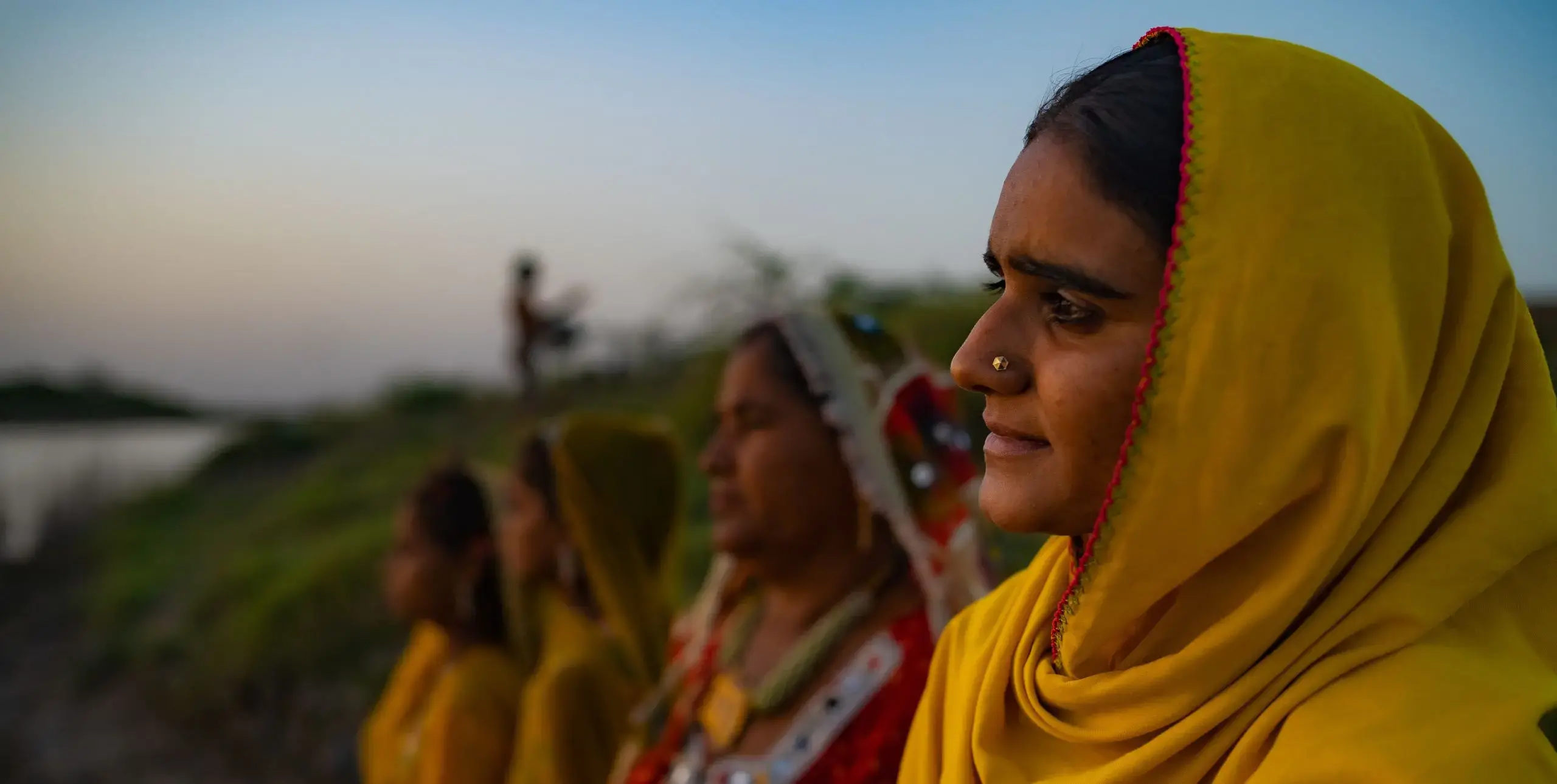 Four South Asian woman look out onto the landscape