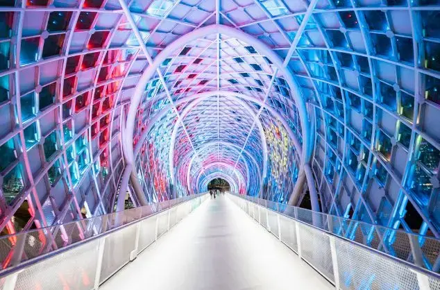 A colourful covered walkway leads forward
