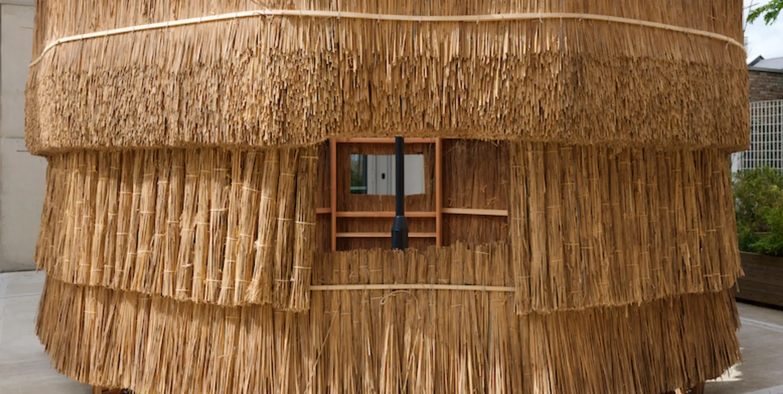 A simple wooden structure that is thatched with straw as part of the AHFA festival