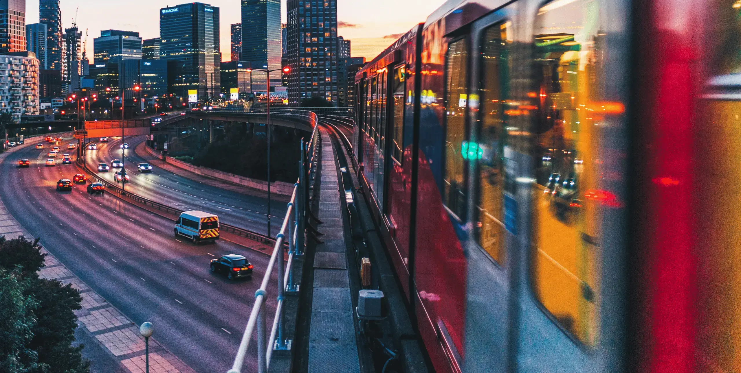 A London train against a city backdrop at evening time