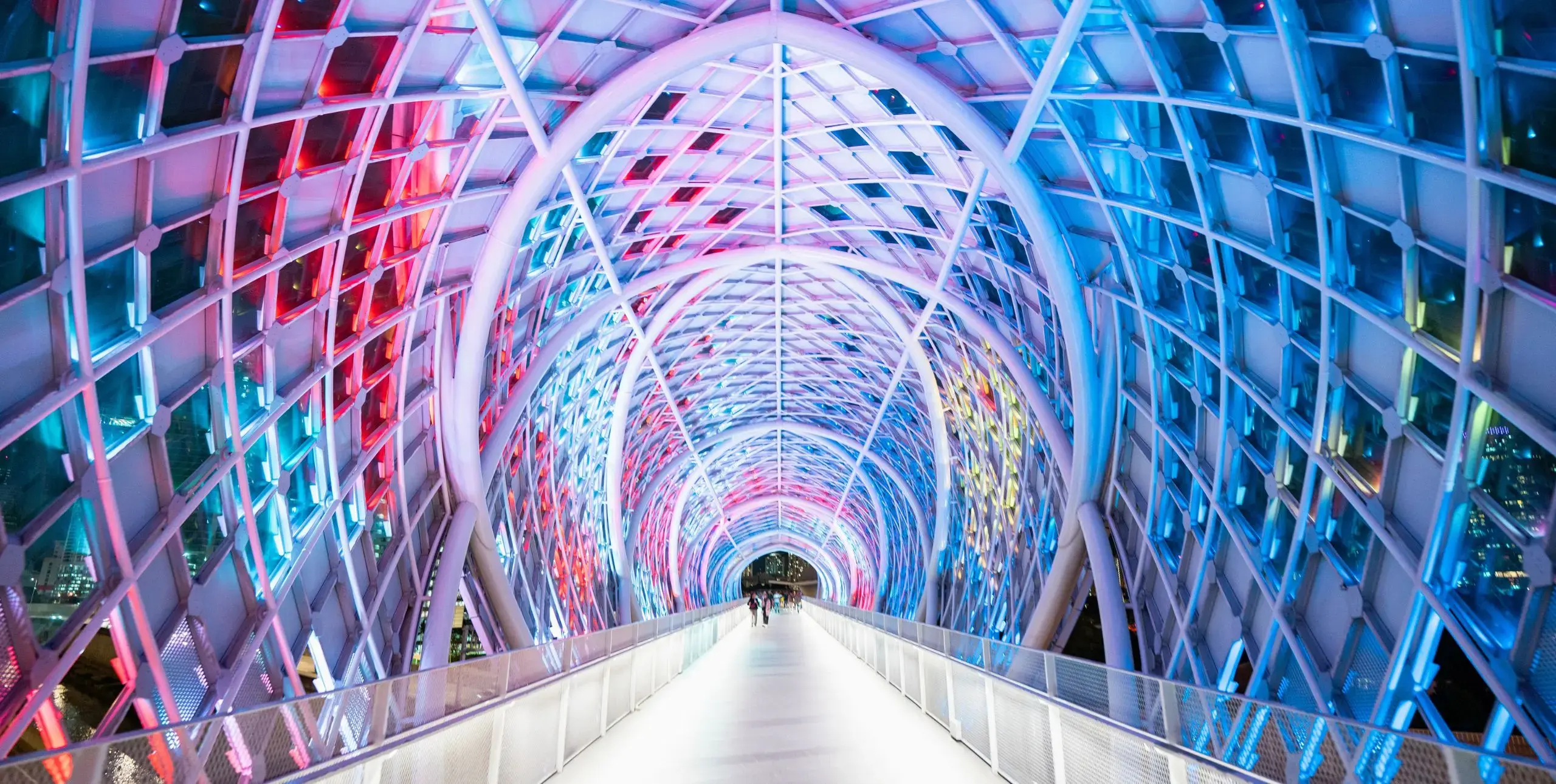 A colourful convention centre corridor leads away from us