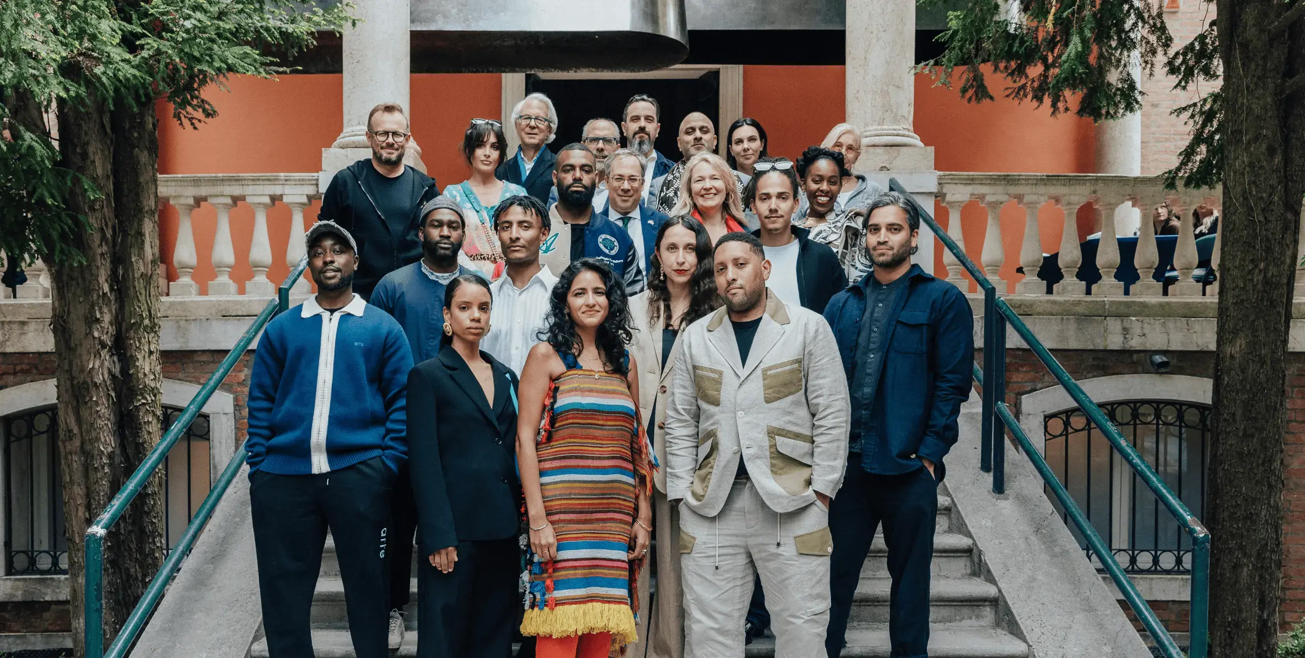 British Council patrons stand on the steps of the British Pavilion alongside the curatorial team for the 2023 exhibition at the Venice Biennale.