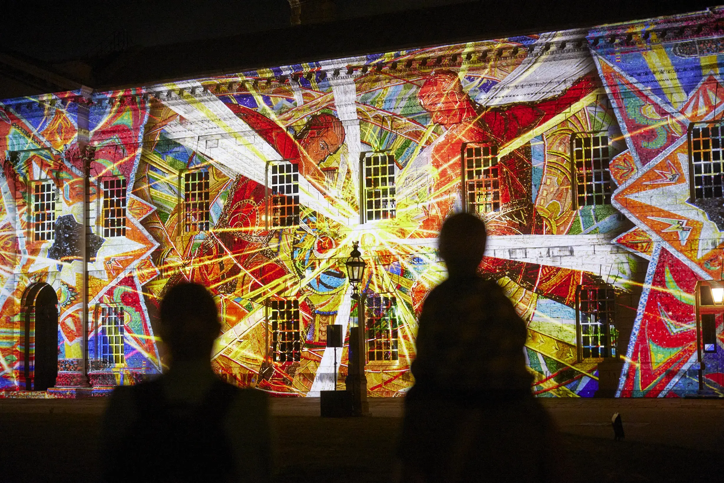 A building in Greenwich London is lit up with vibrant projections of mosaics lost in the war in Ukraine as part of a show called Bits Destroyed for the UK Ukraine Season.