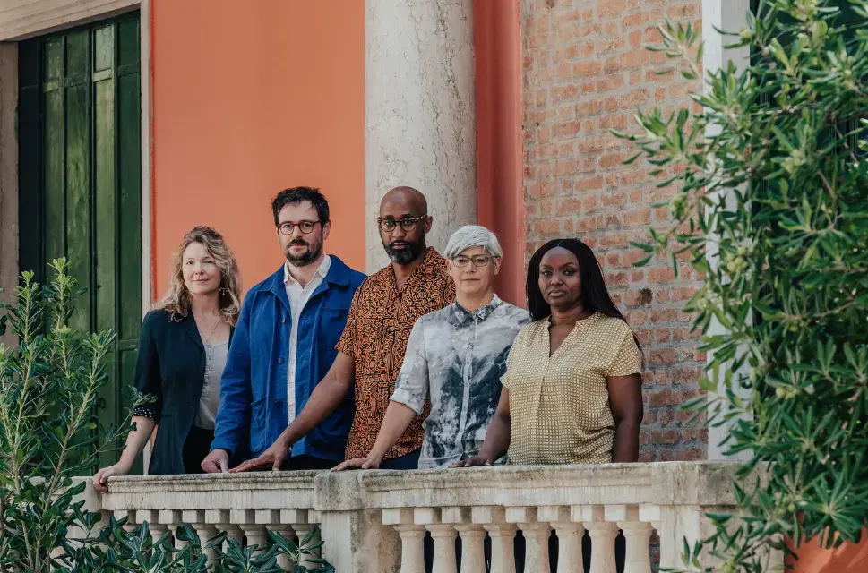 The Venice 2025 curatorial team stand in front of the British Pavilion in Venice