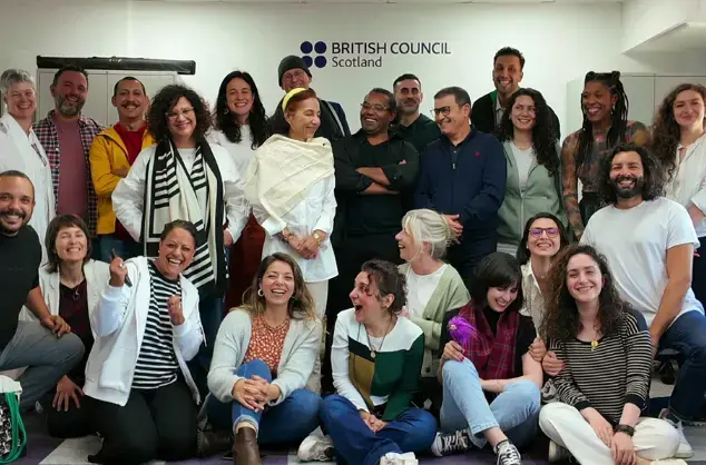 An informal group portrait of the IN BETWEEN x MOMENTUM delegates 2024 at the British Council Scotland offices.