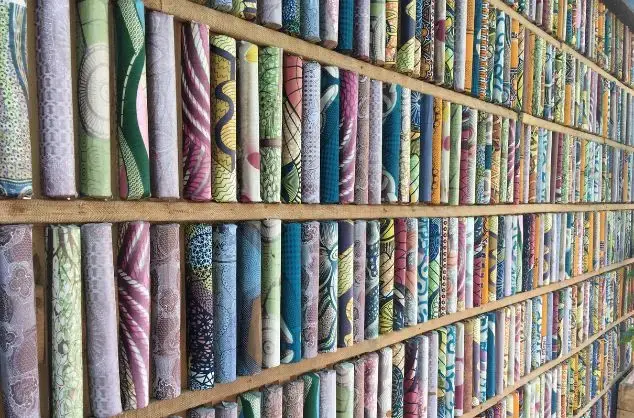 A tall bookshelf full of colourfully bound books at the Kigali public library in Rwanda 