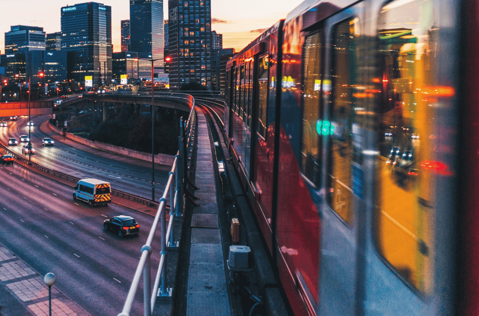A London train against a city backdrop at evening time