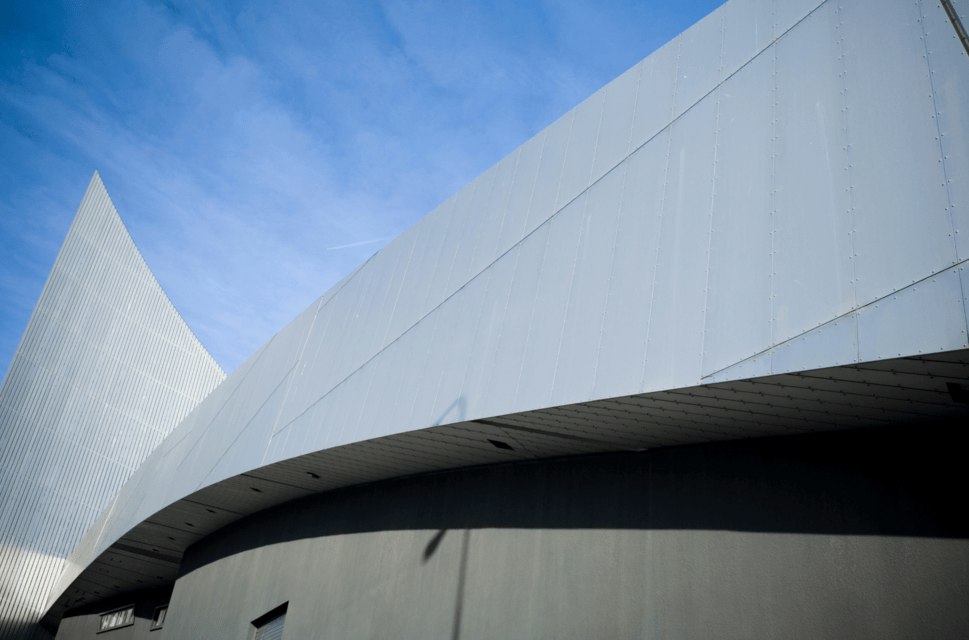 Facade of Imperial War Museum North, Salford, Manchester, England, UK, against a bright blue sky
