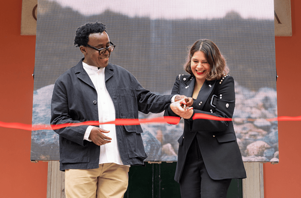 Artist John Akomfrah and curator Tarini Malik cut the ribbon at the British Pavilion opening ceremony at the Venice Biennale 2024. Photo by Cristiano Corte © British Council