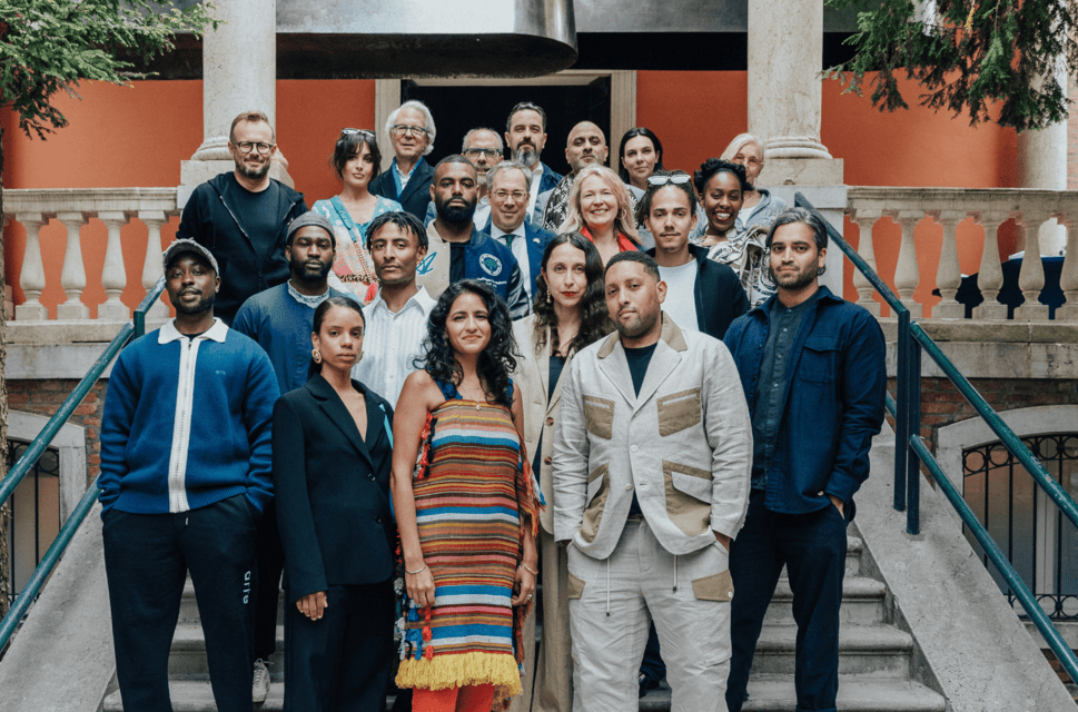 British Council patrons stand on the steps of the British Pavilion alongside the curatorial team for the 2023 exhibition at the Venice Biennale.