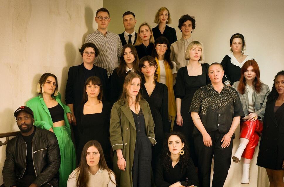 The Granta's Best Young British Novelists 2023 stand staggered on a staircase and look moodily into the camera